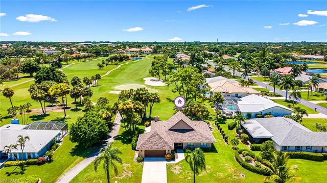 an aerial view of residential houses with outdoor space and street view