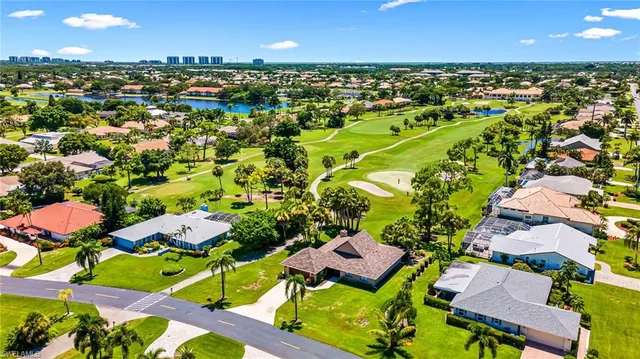 an aerial view of residential houses with outdoor space and street view