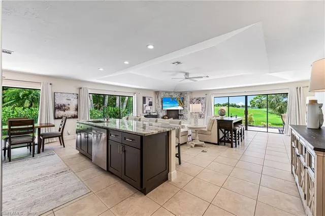 a kitchen with kitchen island a large counter top space and stainless steel appliances