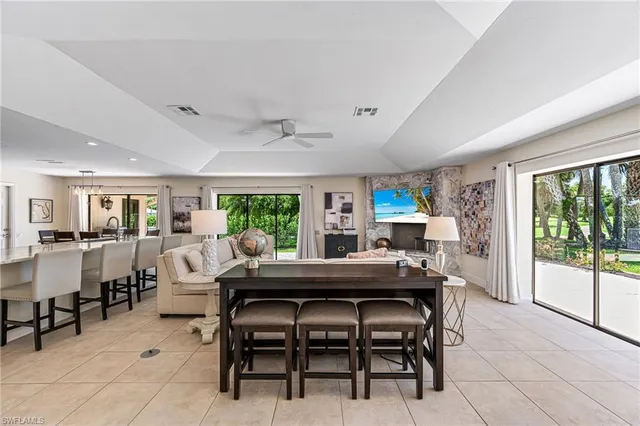 a dining room with furniture and a floor to ceiling window