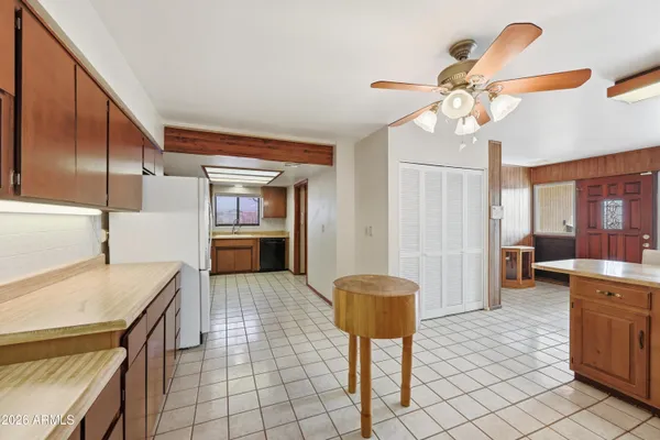 a kitchen with a refrigerator sink and wooden cabinets