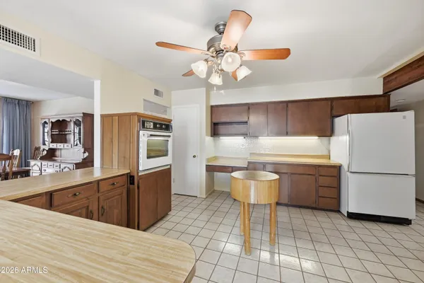 a kitchen with a stove sink and cabinets
