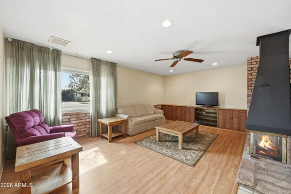a view of a dining room with furniture a chandelier and wooden floor