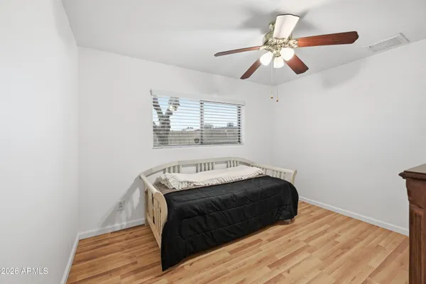 a pathway of a house with potted plants