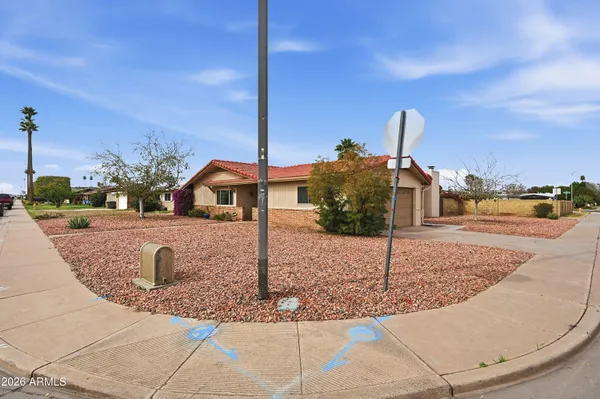 a front view of a house with a yard and street view