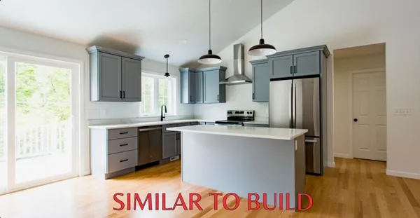 a kitchen with refrigerator a stove a sink and a wooden floor