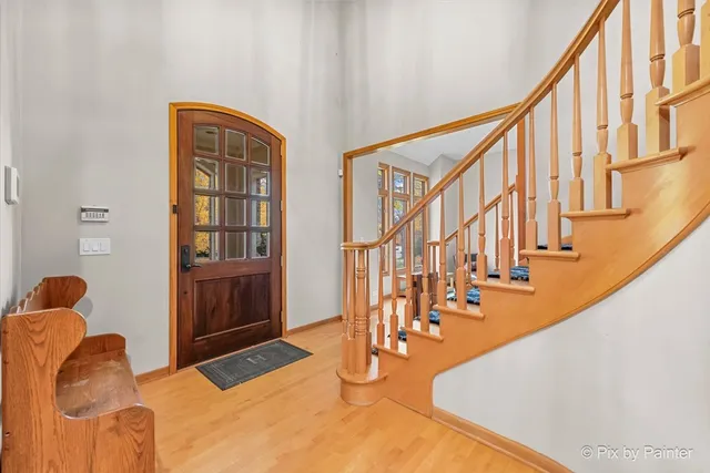 a view of entryway and hall with wooden floor