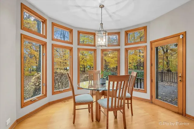 a view of a dining room with furniture large windows and wooden floor