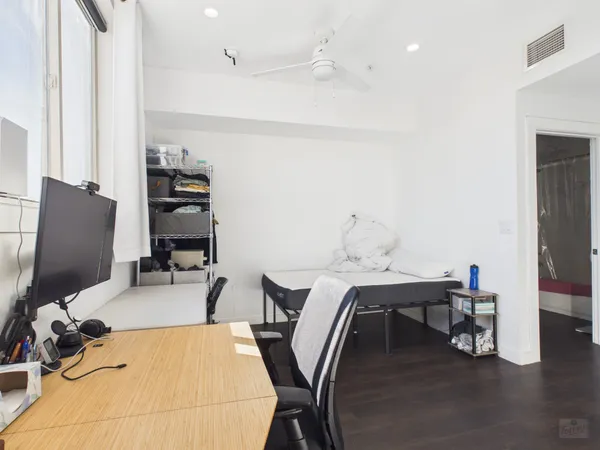 a work room with furniture and a flat screen tv