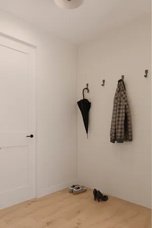 a view of a room with a dresser and a window