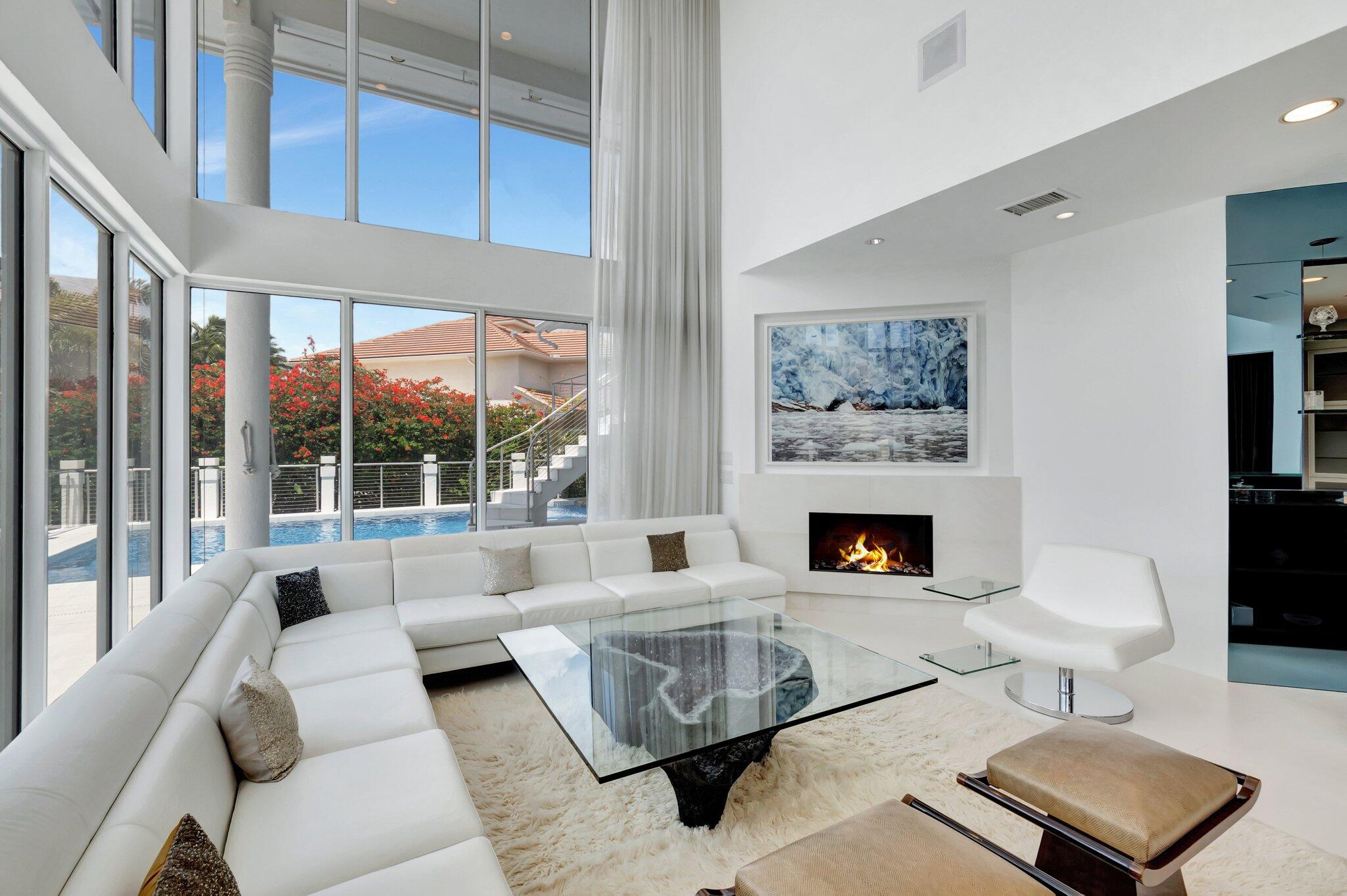 7208 Valencia Drive Boca Raton, FL 33433 - Photo 22 of 73 a living room with furniture a fireplace and a large window