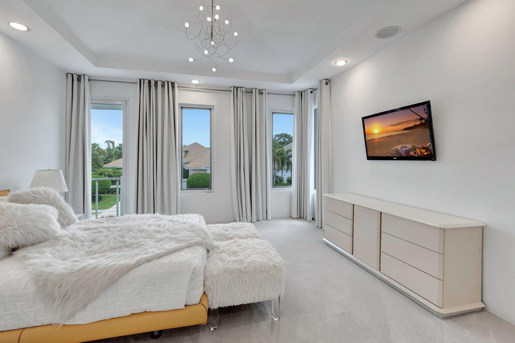 7208 Valencia Drive Boca Raton, FL 33433 - Photo 44 of 73 a bedroom with a bed and a flat screen tv