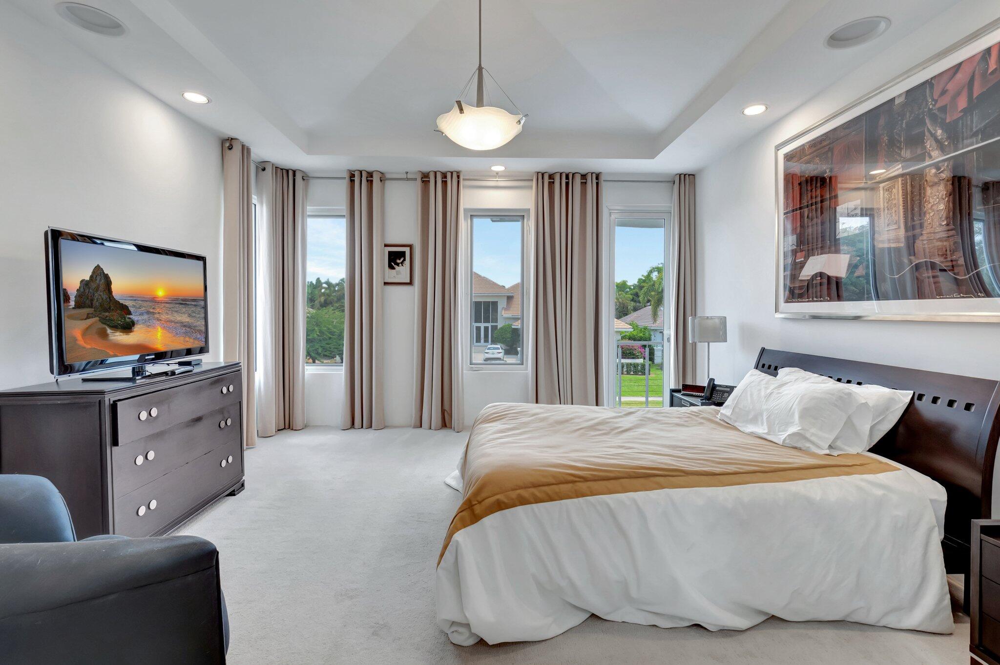 7208 Valencia Drive Boca Raton, FL 33433 - Photo 46 of 73 a bedroom with a bed and glass windows