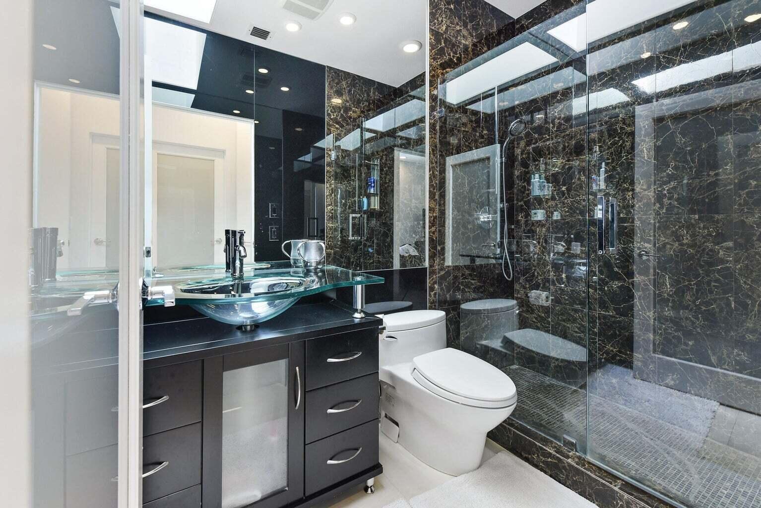 7208 Valencia Drive Boca Raton, FL 33433 - Photo 47 of 73 a bathroom with a granite countertop sink toilet a mirror and shower