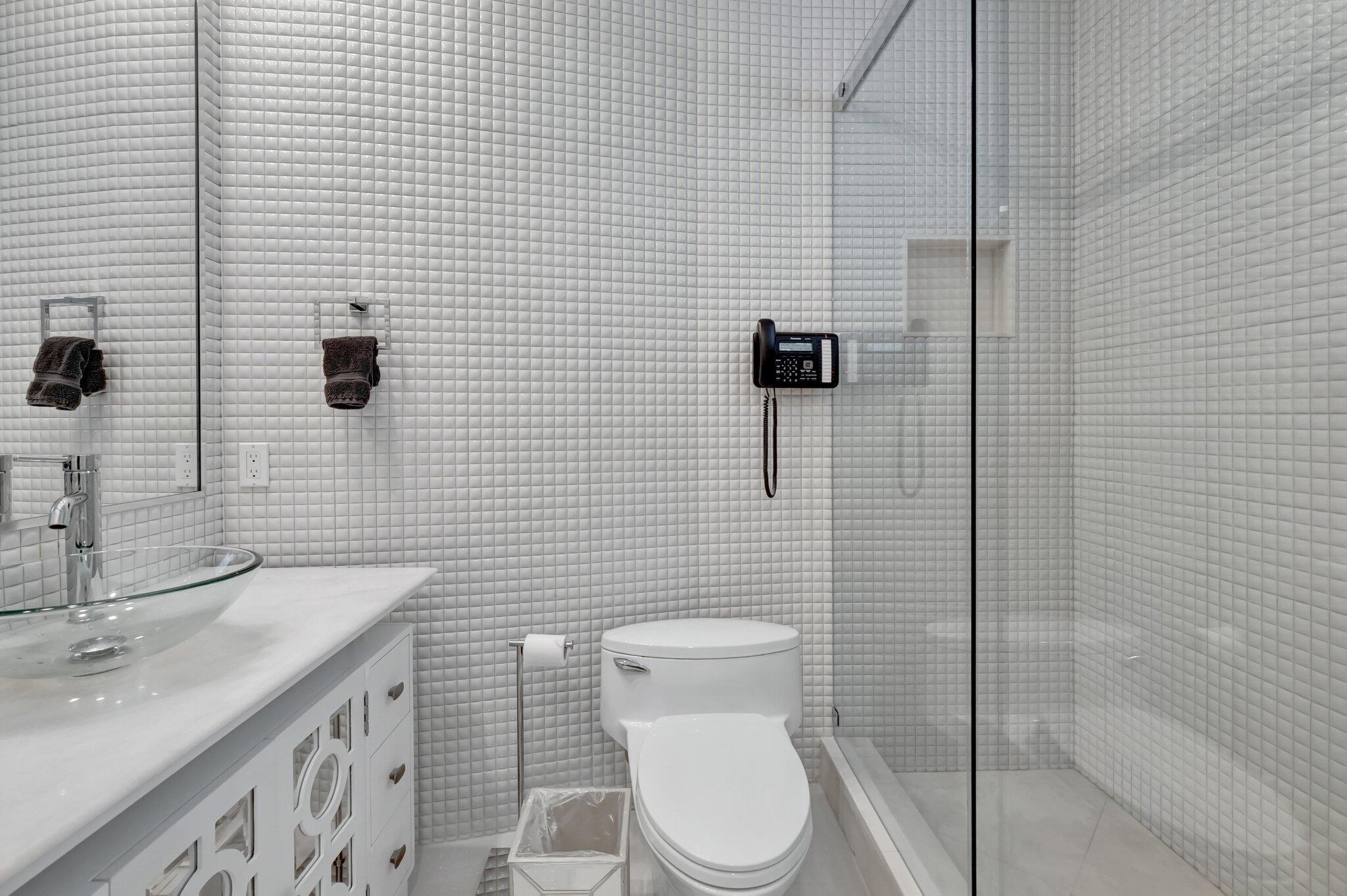 7208 Valencia Drive Boca Raton, FL 33433 - Photo 51 of 73 a bathroom with a granite countertop toilet a sink and mirror