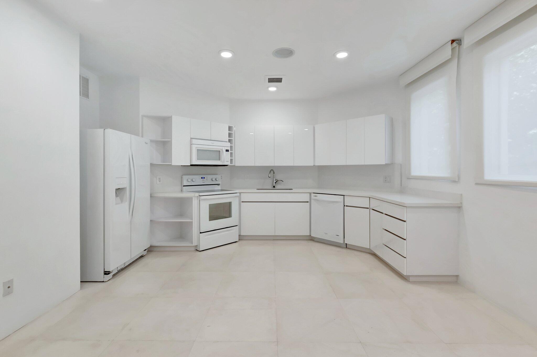 7208 Valencia Drive Boca Raton, FL 33433 - Photo 52 of 73 a kitchen with stainless steel appliances white cabinets and a refrigerator