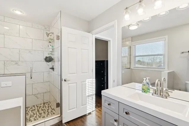 a bathroom with a sink a vanity and a mirror