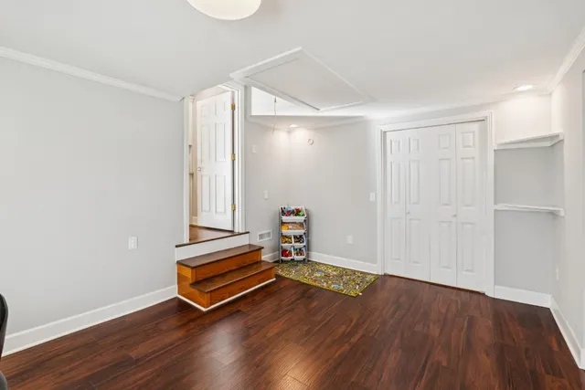 a room with wooden floor and white walls