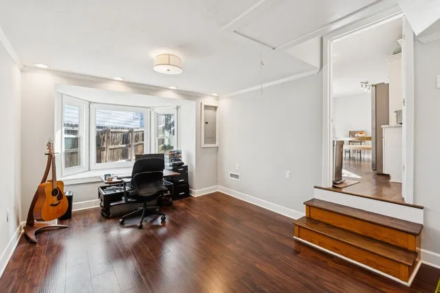 a living room with furniture gym equipment and a large window