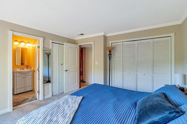 a spacious bedroom with a bed and a shower