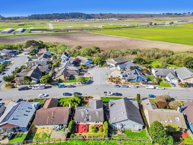 an aerial view of residential houses with outdoor space and street view