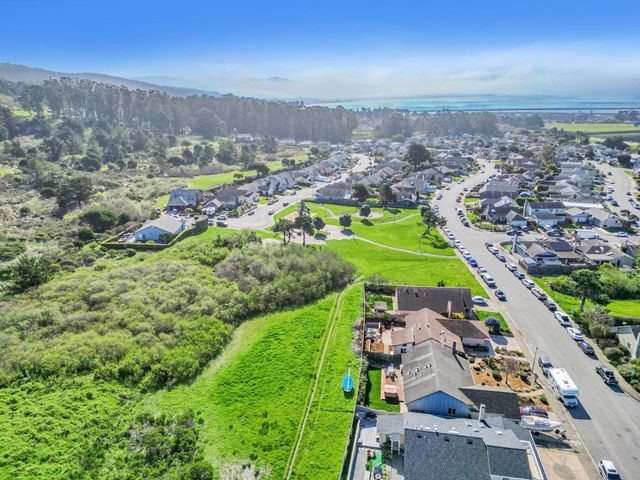 an aerial view of a house with a garden and a yard