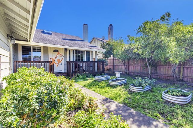 a view of a chair and table in backyard