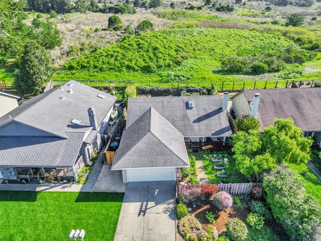 a backyard of a house with outdoor seating