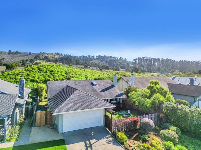 a patio with water fountain plants and outdoor seating