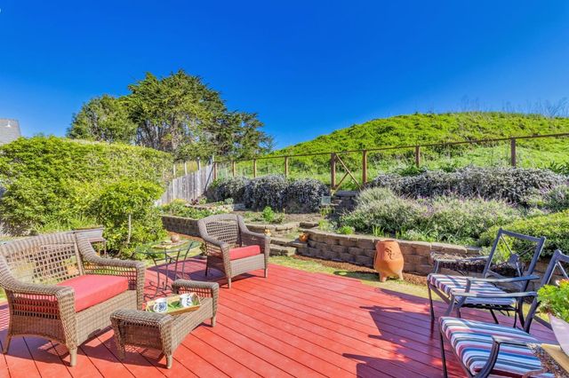a view of a mountain with a lush green forest