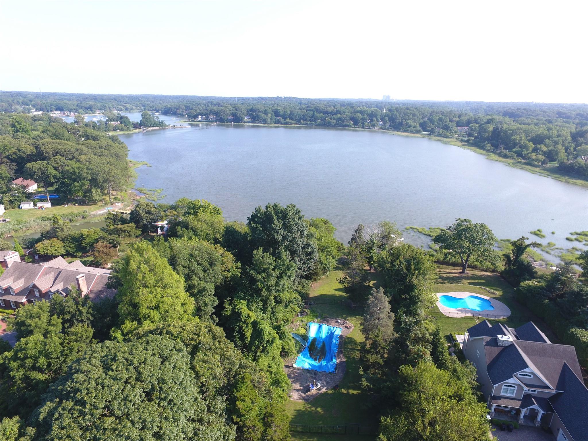 an aerial view of house with yard and lake view