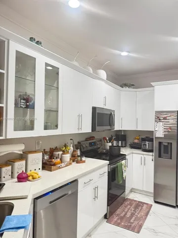 a view of a porch with a table and chairs and potted plants