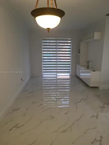 a kitchen with kitchen island a refrigerator sink and cabinets