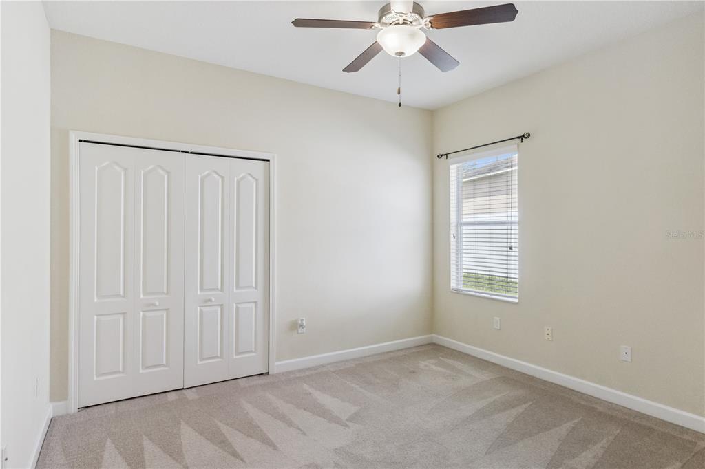 5832 Tarleton Way Mount Dora, FL 32757 - Photo 23 of 31 an empty room with windows and fan