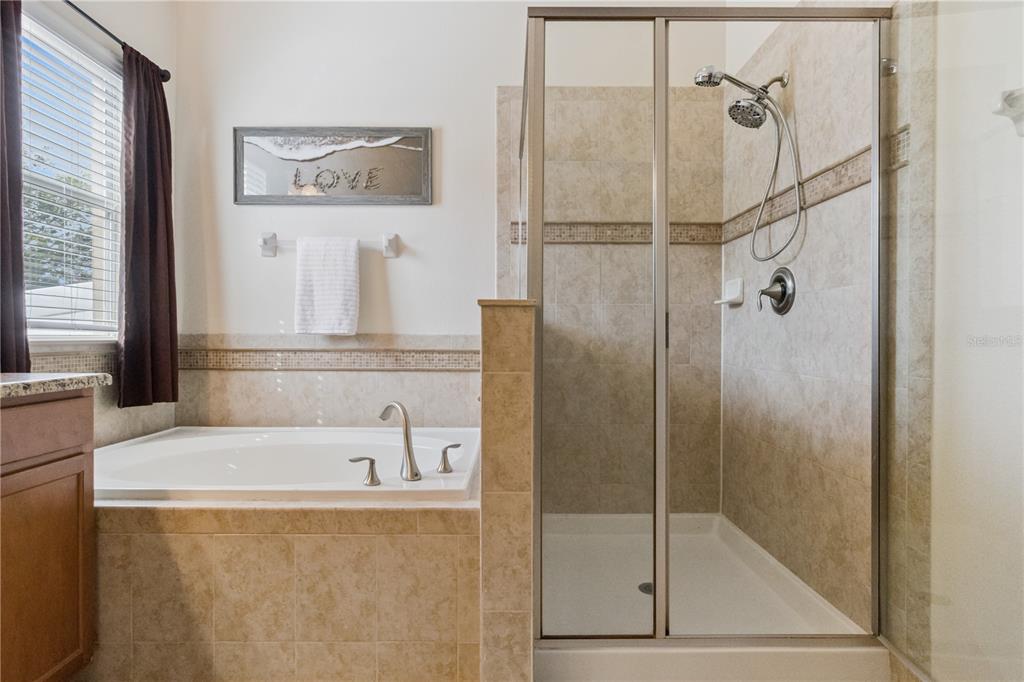 5832 Tarleton Way Mount Dora, FL 32757 - Photo 26 of 31 a bathroom with a bathtub and a shower