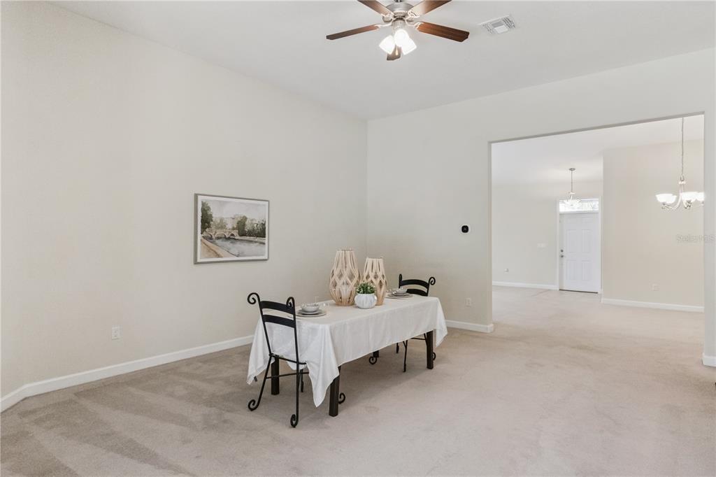 5832 Tarleton Way Mount Dora, FL 32757 - Photo 8 of 31 a bedroom with a bed and a chandelier