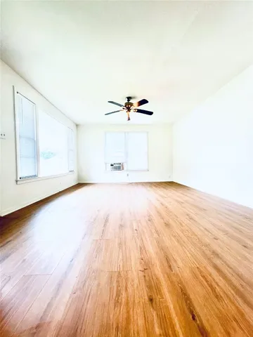 a view of a room with wooden floors