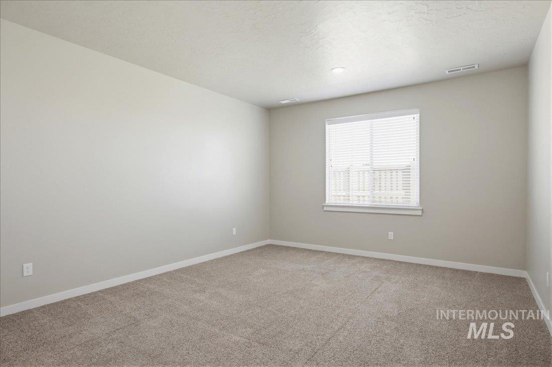 12460 West Azure Street Boise, ID 83713 - Photo 21 of 34 Spacious room featuring carpeting, neutral wall paint, a window with blinds, and recessed lighting