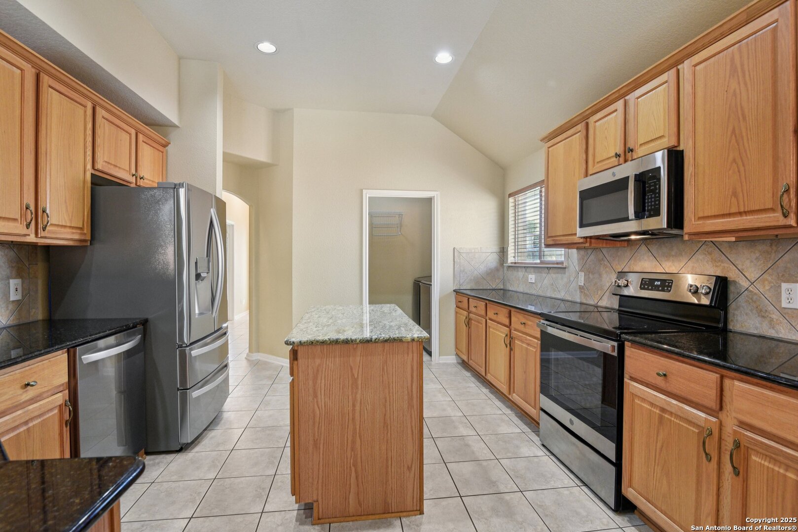 112 Storm Mountain Cibolo, TX 78108 - Photo 12 of 34 a large kitchen with stainless steel appliances granite countertop a refrigerator a stove top oven and a sink
