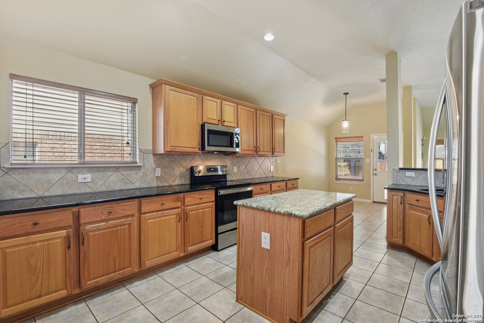 112 Storm Mountain Cibolo, TX 78108 - Photo 13 of 34 a kitchen with stainless steel appliances granite countertop a stove a sink and a refrigerator