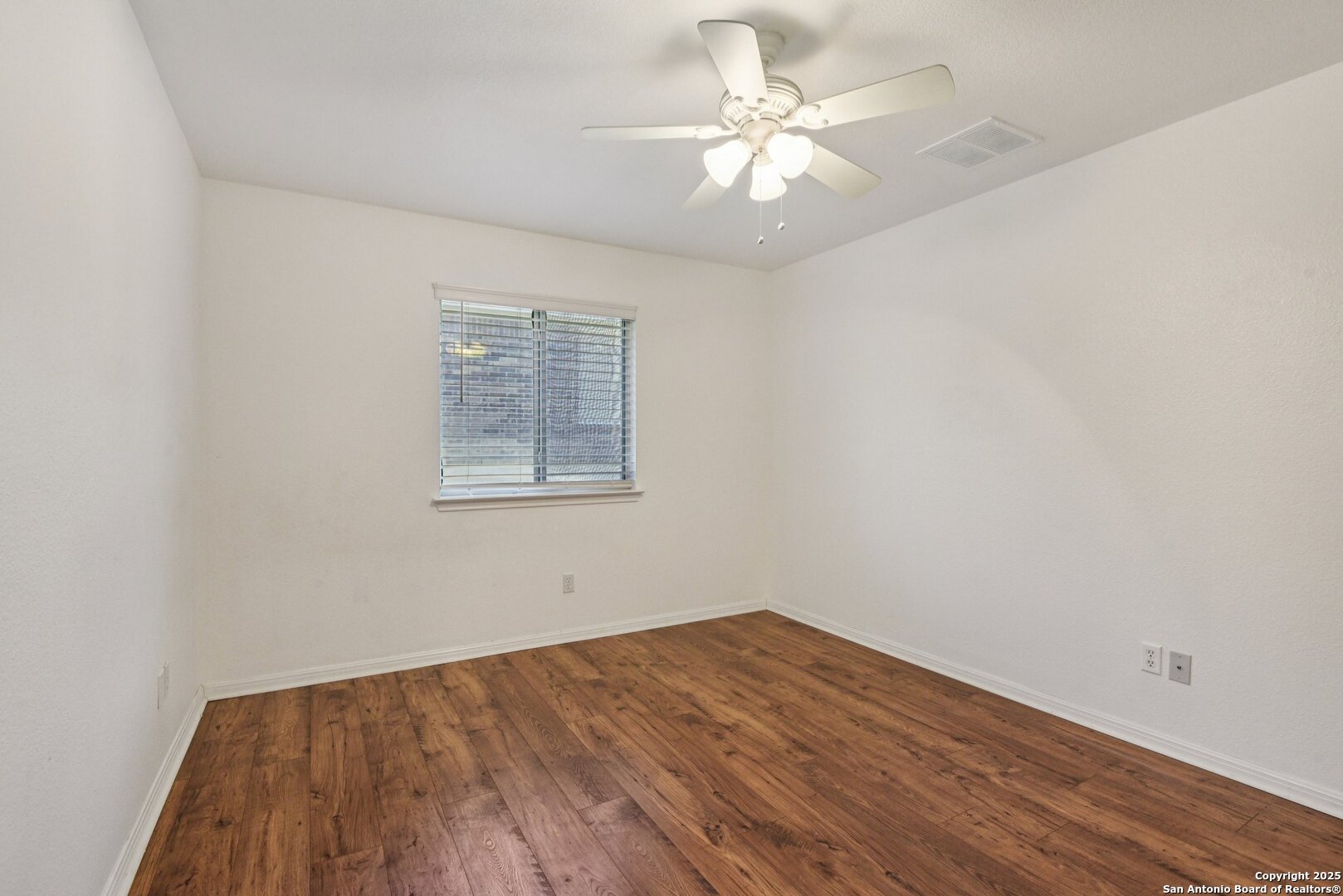 112 Storm Mountain Cibolo, TX 78108 - Photo 24 of 34 an empty room with wooden floor and window