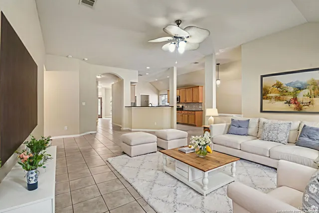 a living room with furniture and a chandelier