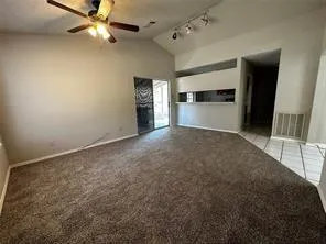 a view of a livingroom with a ceiling fan and window