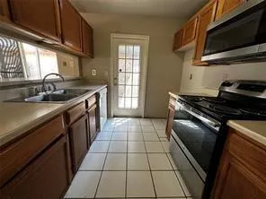a kitchen with a sink a stove and a microwave