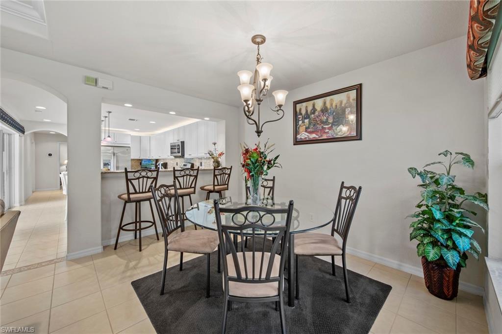 9046 Astonia Way Estero, FL 33967 - Photo 16 of 47 a view of a dining room with furniture and a chandelier