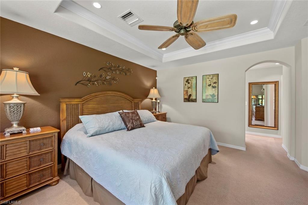 9046 Astonia Way Estero, FL 33967 - Photo 25 of 47 a bedroom with a bed and a chandelier