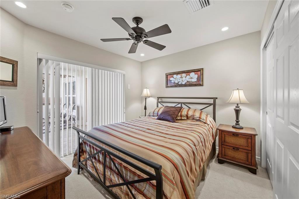 9046 Astonia Way Estero, FL 33967 - Photo 28 of 47 a bedroom with a bed and a chandelier