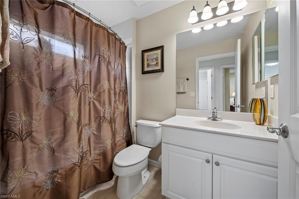 9046 Astonia Way Estero, FL 33967 - Photo 29 of 47 a bathroom with a sink vanity mirror and toilet