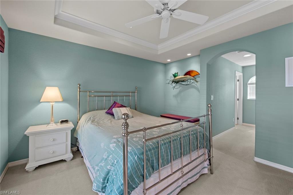 9046 Astonia Way Estero, FL 33967 - Photo 30 of 47 a bedroom with a bed and a chandelier