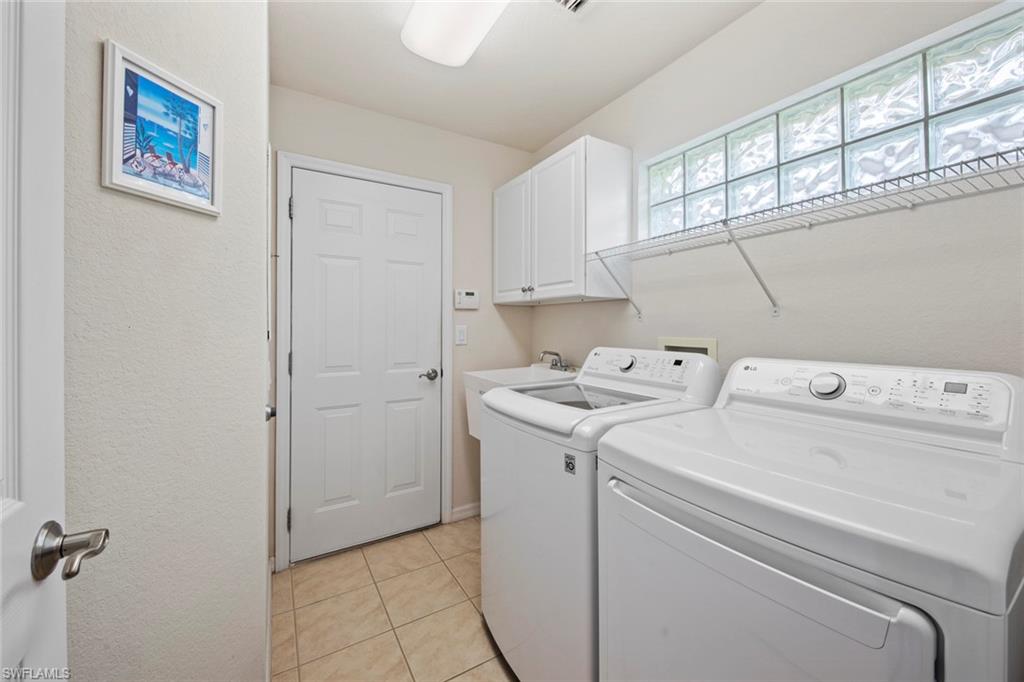 9046 Astonia Way Estero, FL 33967 - Photo 33 of 47 a view of storage and utility room with washer and dryer